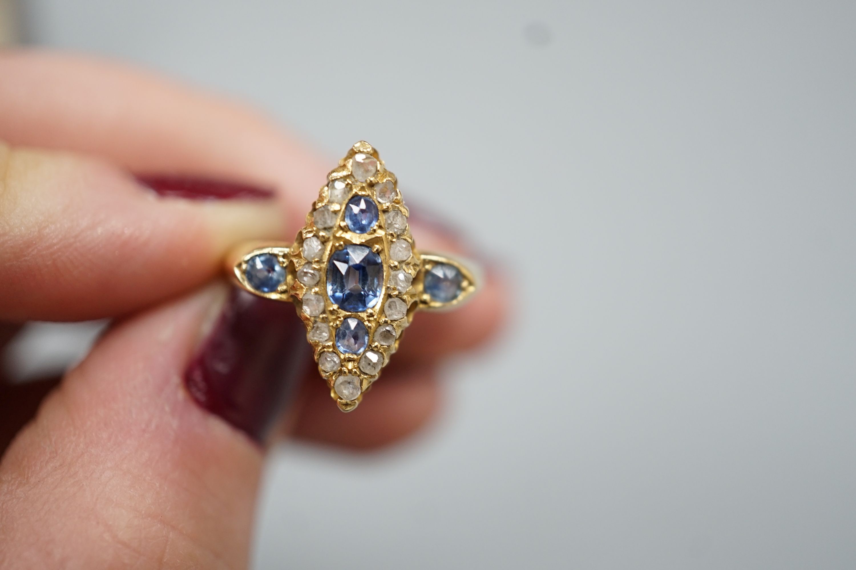 An Edwardian 18ct gold, sapphire and diamond set marquise set cluster ring, size K, gross weight 3.2 grams